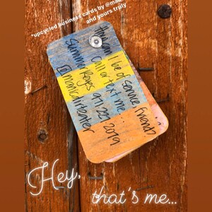 May include: A colourful business card with the text "Hire can I be of service, friend? Call or text me... Summer Reves 971.221.2019 @manicdirteater" written on it.