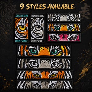 May include: Nine embroidered patches with tiger eye designs are displayed. The patches feature various color combinations, including orange, yellow, white, and black. Text on the patches reads "DEATH STARE" and "DARK FOREST".