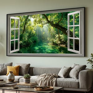 May include: A framed wall art piece depicting a vibrant forest scene viewed through an open window. The artwork showcases a lush green forest with a river, sunlight streaming through the trees, and white window frames.