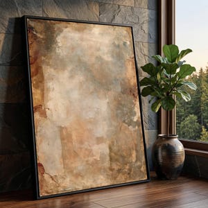 May include: A rectangular framed wall art piece featuring an abstract composition with layered textures in shades of beige, tan, brown, and muted gray. The artwork is enclosed in a thin black frame, displaying a weathered, plaster-like appearance.