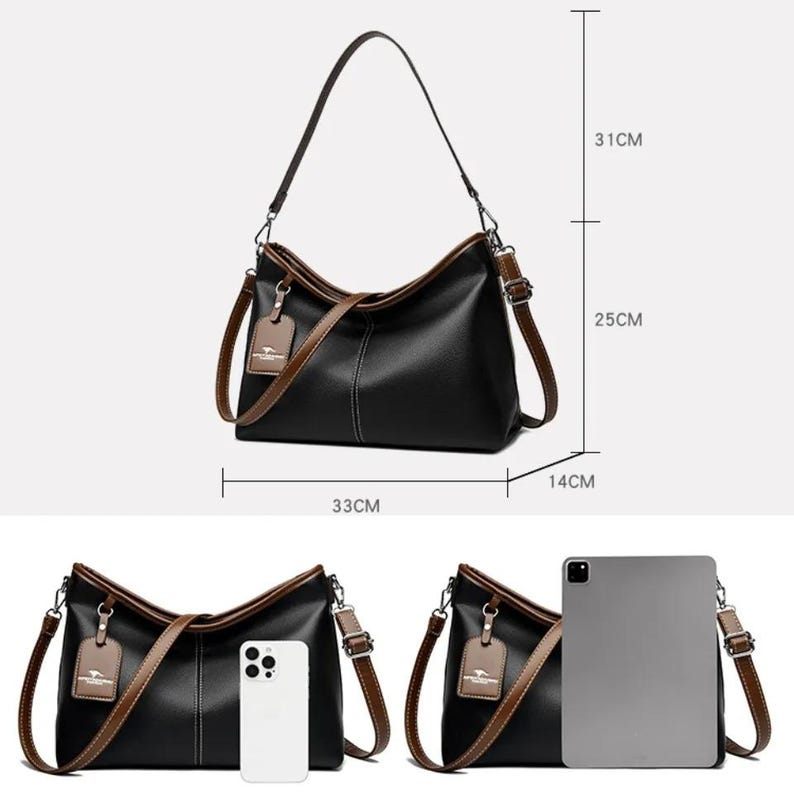 Pu&ograve; includere: Borsa a tracolla nera con finiture e cinturini marroni. La borsa &egrave; larga 33 cm, alta 25 cm e profonda 14 cm. Ha una tracolla lunga e un manico pi&ugrave; piccolo. Una piccola etichetta pende dalla tracolla.