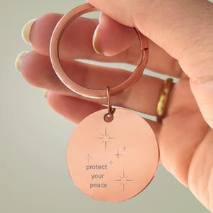 Protect Your Peace Engraved Round Keychain: Stainless Steel, Rose Gold Tone, Stars, Mindfulness Reminder