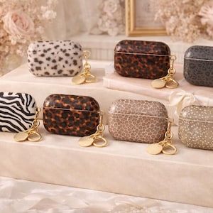 May include: A set of three ceramic mugs with a speckled, matte finish. Each mug features a different color: light blue, cream, and gray. The mugs have a simple, modern design and a comfortable handle.