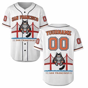 May include: White baseball jersey with black trim, featuring the text "SAN FRANCISCO" and a cartoon cat on the front. The back displays "YOURNAME" and the number "00". The jersey has orange and black accents.