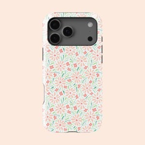May include: A white phone case with a repeating pattern of pink daisies, small red flowers, and green leaves. The case has a camera cutout and a black border.