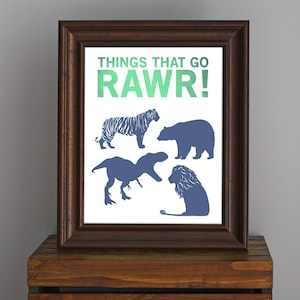 May include: A framed print with the text "Things that go RAWr!" in green and blue. The print features silhouettes of a tiger, bear, dinosaur, and lion.