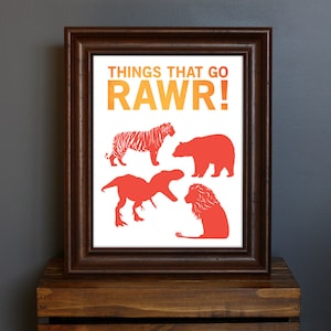 May include: A framed print with the text "Things that go RAWr!" in orange and yellow. The print features red silhouettes of a tiger, bear, dinosaur, and lion.