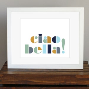 May include: A white framed print with the text "ciao bella!" in a colorful geometric font. The text is in shades of blue, green, yellow, and white.