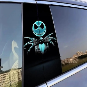 May include: A black car window sticker featuring a teal illustration of Jack Skellington from The Nightmare Before Christmas. The design includes his skeletal face and bat-like bow tie. The sticker is applied to a car window.