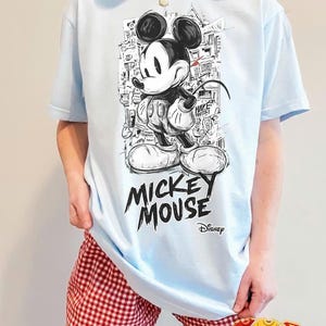 May include: A set of three ceramic mugs with a speckled, matte finish in cream, light grey, and dark grey. Each mug has a simple, minimalist design and a rounded handle.