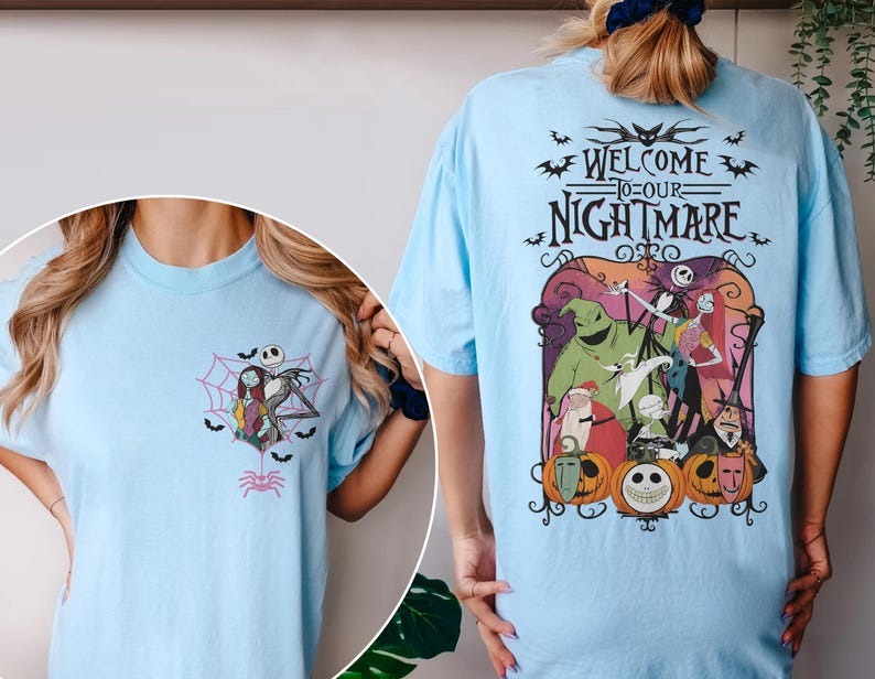 May include: Light blue t-shirts featuring graphics from "The Nightmare Before Christmas." One shirt has a small front graphic of Jack and Sally in a spiderweb. The other shirt has a large back graphic with the text "Welcome to our Nightmare."