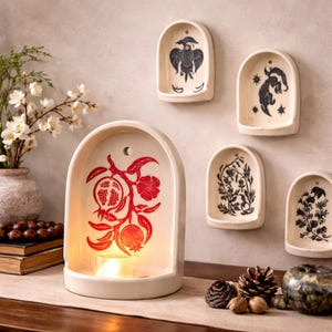 May include: A white ceramic mug with a black handle and the text "But First, Coffee" in a handwritten style. The mug is on a white surface. The mug is 4 inches tall.