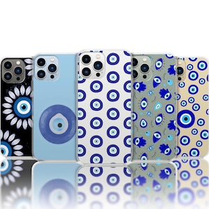 May include: A collection of phone cases with various designs featuring the evil eye symbol. The cases display different patterns, including a large eye, floral arrangements, and repeating eye motifs in blue and white on black, light blue, and beige backgrounds.
