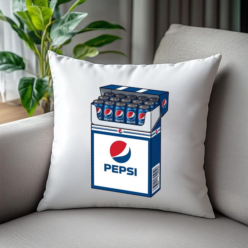 May include: A white square throw pillow featuring a graphic illustration of a blue and white Pepsi carton box filled with multiple blue soda cans. The Pepsi logo is printed in red, white, and blue on the front of the box, with the text Pepsi below.