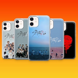 May include: A white ceramic mug with a black handle and the text "But First, Coffee" in a bold, black font. The mug is set against a blurred background, suggesting a cosy setting.