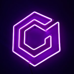 May include: A neon sign in the shape of a stylized letter "G" within a hexagon. The sign glows with a bright purple light against a dark background. The design features multiple layers of neon tubing.