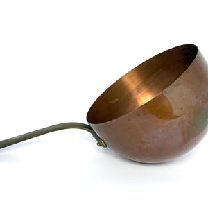 May include: A white ceramic mug with a black handle and the text "But First, Coffee" in a black, bold font. The mug is sitting on a white surface.