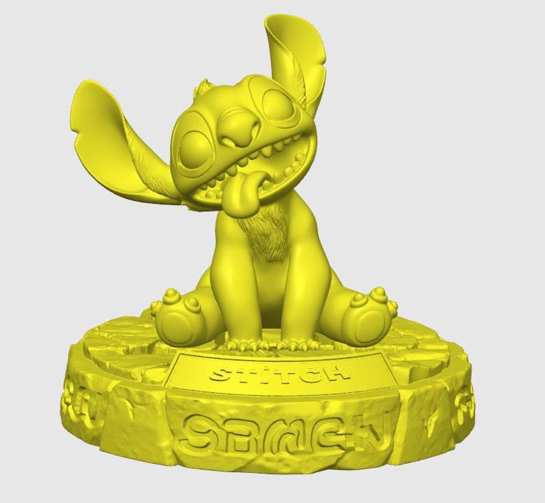 May include: A yellow figurine of the character Stitch from Lilo & Stitch. The figurine is in a sitting position with its tongue sticking out. The base of the figurine has the word "Stitch" and "Game" on it.