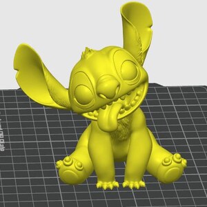 May include: A yellow 3D-printed figurine of the character Stitch from the animated film Lilo & Stitch. The figurine is in a sitting position with its tongue sticking out and large ears. The figure has a smiling expression.