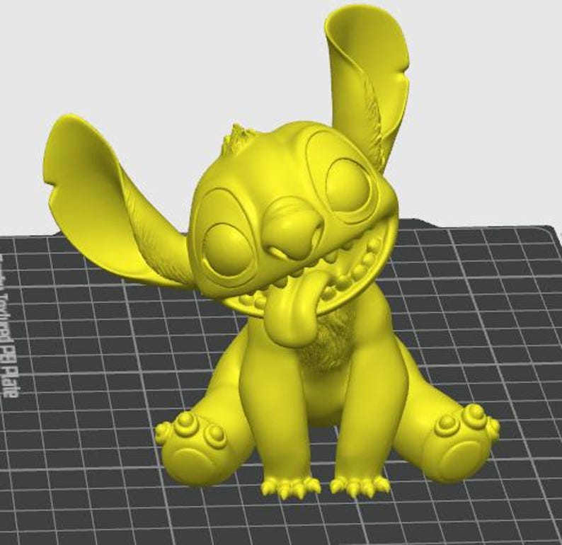 May include: A yellow 3D-printed figurine of the character Stitch from the animated film Lilo & Stitch. The figurine is in a sitting position with its tongue sticking out and large ears. The figure has a smiling expression.