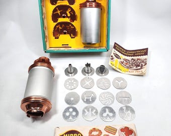 2 Mirro Cookie Presses 1 Dial-a-Cookie, 1 Reg Press + 12 Discs, 3 Tips, Instruction/Recipe Booklets