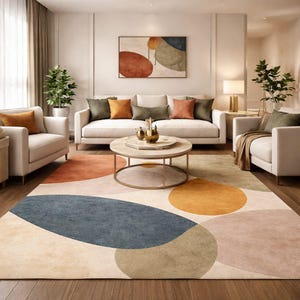 Handmade abstract wool rug with scalloped edges featuring organic shapes in rust, beige, ivory, grey, and charcoal tones on wooden floor in modern living room setting