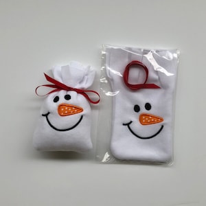 May include: Two white fabric snowman gift bags with red ribbon and orange felt noses. The smaller bag is tied with a red ribbon and the larger bag is in a clear plastic bag.