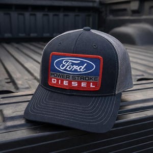 May include: A handmade wooden sign with the text "Welcome" in a handwritten style. The sign is painted white with a distressed finish and features a small, decorative heart. It is designed for indoor or outdoor use.