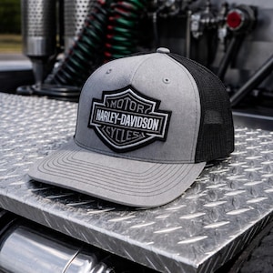 May include: A set of three ceramic mugs with a speckled, matte finish. The mugs are in shades of cream, light gray, and dark gray. Each mug has a simple, minimalist design, perfect for coffee or tea.