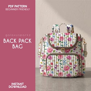 May include: A quilted backpack bag featuring a white base with a colorful floral print of pink roses, yellow daisies, and blue flowers. The bag includes a top handle, adjustable straps, a front pocket, and gold-tone hardware. Text reads: PDF PATTERN BEGINNER FRIENDLY, galaxysparkz, BACK PACK BAG, INSTANT DOWNLOAD.