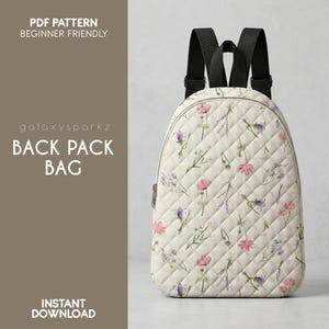 May include: Cream-colored backpack with a floral pattern of pink and purple flowers. The bag has black straps and a zipper closure. The text "PDF PATTERN BEGINNER FRIENDLY" and "BACK PACK BAG" are visible.