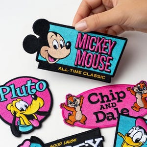 May include: A set of three ceramic mugs with a speckled, matte finish. The mugs are in shades of blue, green, and white. Each mug has a rounded shape and a simple, modern design. The mugs are suitable for coffee, tea, or other beverages.