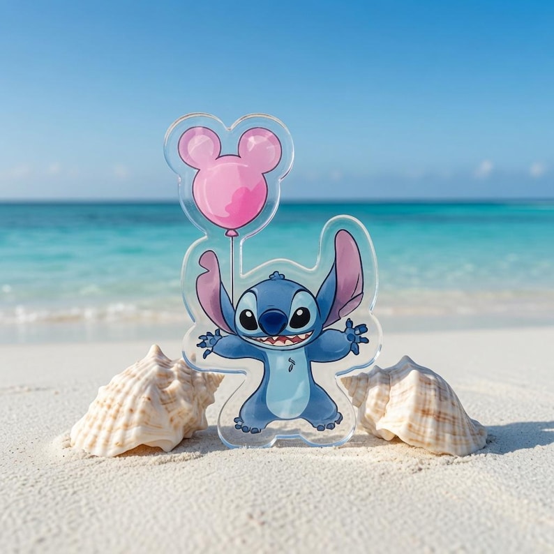 May include: A clear acrylic standee featuring a blue alien character with large ears and a wide grin, holding a pink balloon shaped like a mouse head. The character has a light blue chest patch and dark blue limbs, presented as a flat cutout figure.