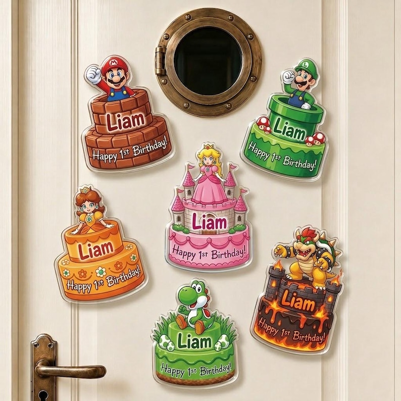 May include: Six decorative wall decals featuring Super Mario characters on birthday cakes with the name Liam and the text Happy 1st Birthday. The designs include Mario, Luigi, Princess Peach, Princess Daisy, Yoshi, and Bowser on a white door.