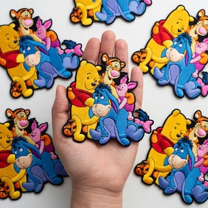 May include: A white ceramic mug with a black handle and the text "But First, Coffee" in a black, bold font. The mug is sitting on a wooden surface. The mug is approximately 4 inches tall.