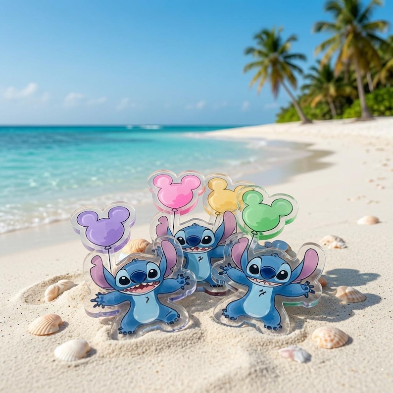 May include: Three clear acrylic charms featuring the blue character Stitch, each holding a different coloured balloon shaped like mouse ears in purple, pink, yellow, and green, arranged on a sandy beach with ocean waves in the background.