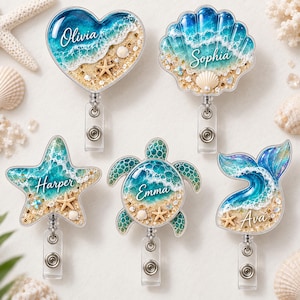May include: Five badge reels featuring ocean-themed designs with sand, white foam, and blue water. The shapes include a heart, seashell, starfish, sea turtle, and whale tail. Each piece is personalized with the names Olivia, Sophia, Harper, Emma, and Ava.