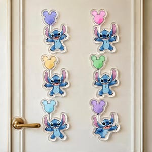 May include: Six acrylic wall decals featuring the blue character Stitch, each holding a different coloured balloon shaped like a mouse head. The balloons are purple, pink, yellow, green, light blue, and lavender, arranged in two vertical columns.