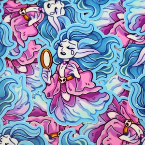 May include: A sticker featuring a blue-haired, crying fairy with pink and blue wings. She is holding a gold-rimmed mirror and wearing a pink dress with a skull and crossbones design. The sticker is surrounded by other similar stickers.
