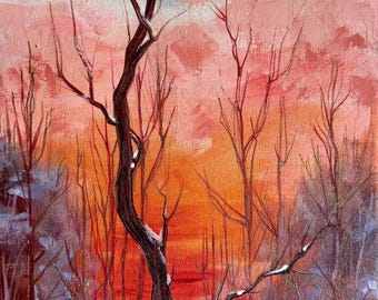 May include: An oil painting on canvas depicting a winter landscape with bare trees against a vibrant sunset. The sky transitions from pale blue to soft pink and intense orange. Snow covers the ground, and a signature is visible in the bottom right.