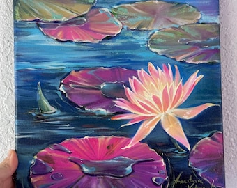 May include: An oil painting on canvas depicting a vibrant pink water lily in full bloom surrounded by dark blue water and several lily pads in shades of green, purple, and pink. The artist's signature is visible in the bottom right corner.