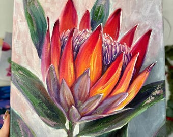 May include: An acrylic painting on canvas depicting a vibrant protea flower with red, orange, and purple petals. The center features textured white stamens, surrounded by dark green leaves. The artist's signature, Anastasia Yatsunenko, is in the corner.