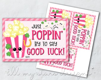 May include: Pink and green printable gift tags with a cartoon popcorn bucket and the text "Just Poppin' by to say Good Luck!"