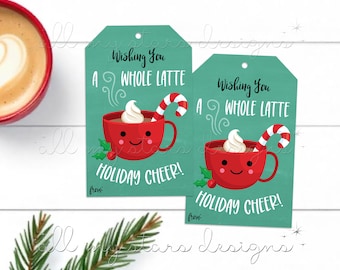 May include: Two teal gift tags with a red and white cartoon mug of hot chocolate with whipped cream and a candy cane. The text on the tags reads "Wishing you a whole latte holiday cheer!"
