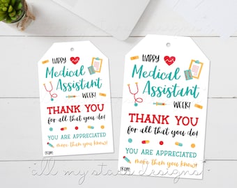 May include: Two white gift tags with a red heart, a stethoscope, a syringe, pills, and a clipboard with a medical chart. The text on the tags reads "Happy Medical Assistant Week! Thank you for all that you do! You are appreciated more than you know!"