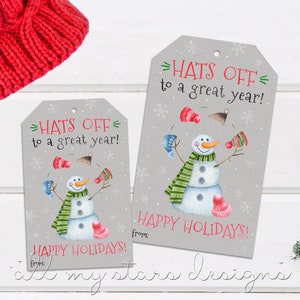 May include: Two gray gift tags with a snowman illustration and the text "HATS OFF to a great year!" and "HAPPY HOLIDAYS!"