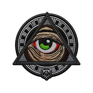 May include: Embroidered patch featuring an eye within a triangle, surrounded by a circular border. The eye has a red iris, green pupil, and brown and tan details. The patch has a black and white color scheme.
