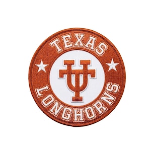 Puede incluir: Parche circular con las palabras "TEXAS LONGHORNS" en letras blancas sobre un fondo naranja. El centro presenta un logotipo "UT" blanco en un diseño estilizado, con dos estrellas blancas a cada lado.