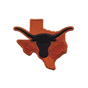 May include: Embroidered patch depicting the outline of Texas in a burnt orange hue, with a black longhorn head at the centre. The patch has detailed stitching and a textured finish, ideal for attaching to garments or accessories.