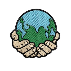 May include: Embroidered patch featuring a stylized Earth held in two hands. The Earth is green with blue oceans, and the hands are tan with black outlines. The patch has a black border.
